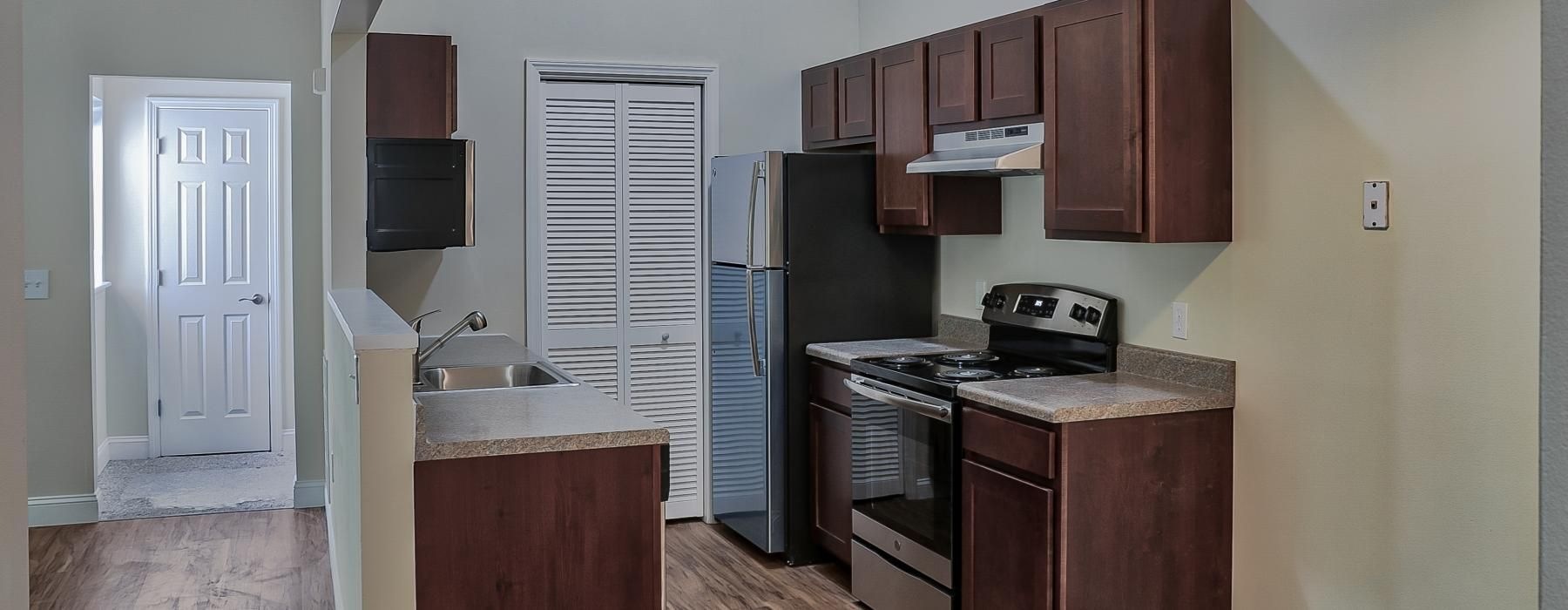 a kitchen with wooden cabinets