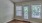 a room with windows and a wood floor