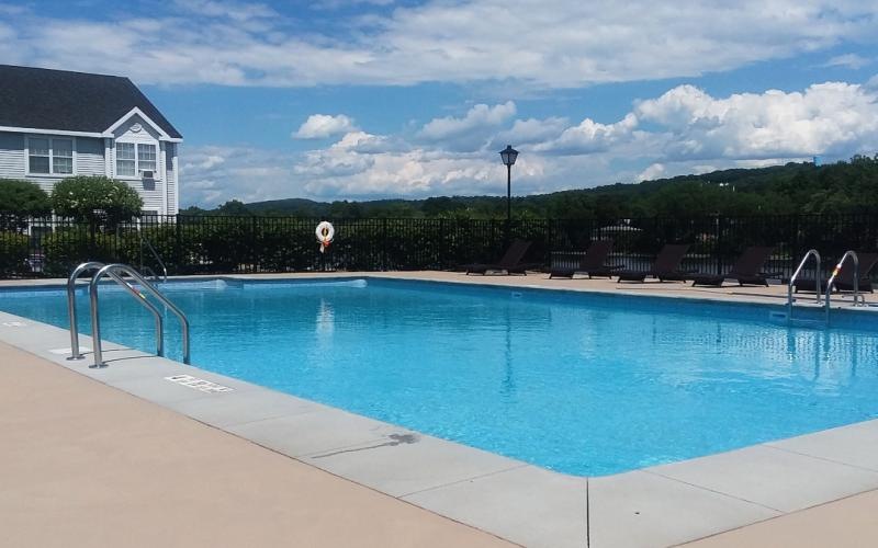 a swimming pool with a building in the background